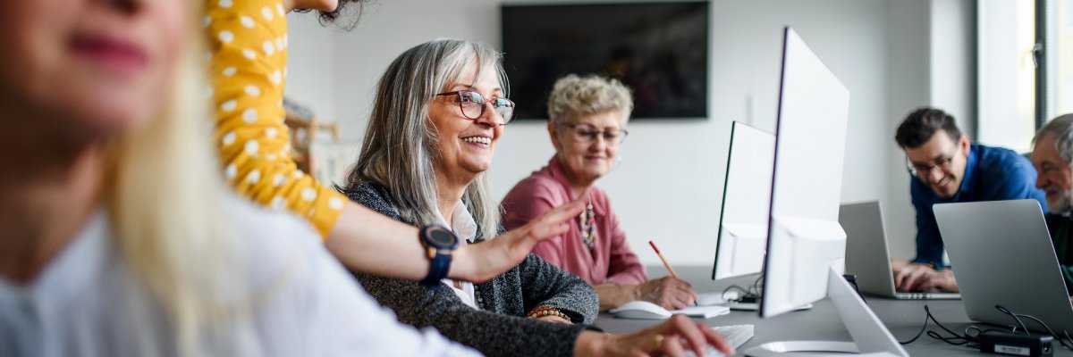 Group of senior people attending computer and technology education class. Group of senior people attending computer and technology education class.