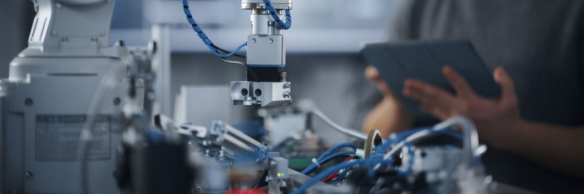 Student Holding Tablet and Controlling Robot Hand Moving at Diff Student Holding Tablet and Controlling Robot Hand Moving at Diff