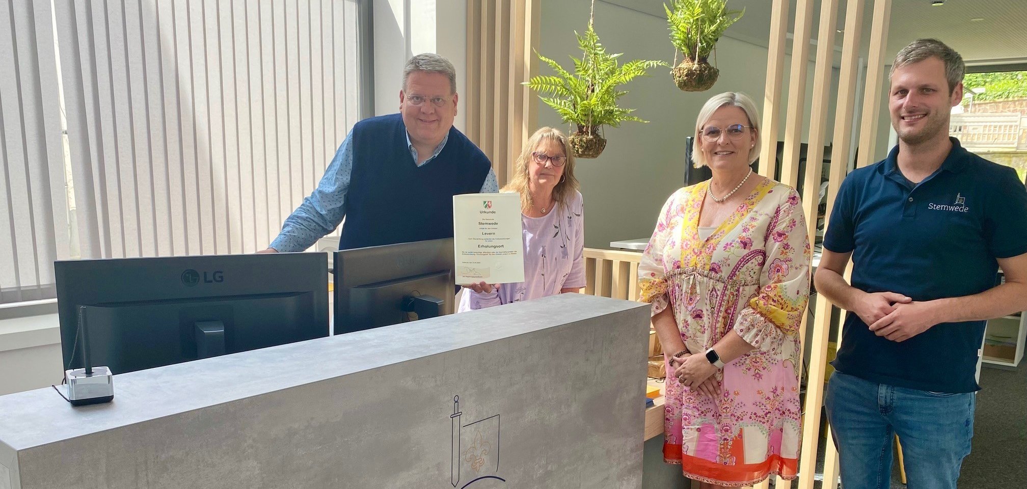 Vier Personen, die am Empfangstresen des Stemweder Bürgerservices stehen.